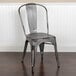 A Flash Furniture distressed silver metal restaurant chair with vertical slat back.
