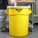 a yellow garbage can with a plastic bag