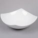 An American Metalcraft white square stoneware bowl on a gray surface.