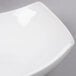 An American Metalcraft white square stoneware bowl on a gray surface.