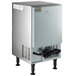 An Avantco silver rectangular undercounter ice machine with black wires.