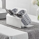 a silver container with silverware in it