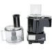 A black Waring food processor with a clear container on top.