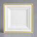 A white square plate with gold trim.