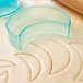 A Ateco plastic plain crescent cookie cutter on dough.