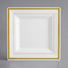 A white square plate with gold trim.