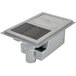 A metal Eagle Group water tempering system with a stainless steel grating over a drain hole.