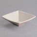 A white square bowl with a square shape on a gray surface.