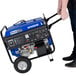 A man pushing a DuroMax portable generator with blue accents.