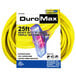 A close-up of a DuroMax yellow extension cord with yellow plugs.