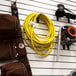 A wall with a DuroMax extension cord and tools.
