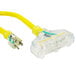A close up of a yellow DuroMax extension power cord with three plugs.
