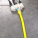 A yellow extension cord with black outlets.