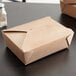 A brown Fold-Pak Bio-Plus-Earth paper take-out box with a lid.