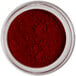 A container of Roxy & Rich Cornelian Petal Dust, a red pigment powder.