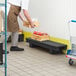 A man in an apron standing next to a Regency narrow dunnage rack.