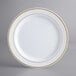 A white Visions plastic plate with gold trim.