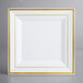 A white square plate with gold trim.