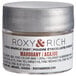 A silver container of Roxy & Rich Mahogany Sparkle Dust with a white label.