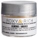 A silver Roxy & Rich container of Almond Sparkle Dust powder.