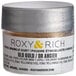 A silver Roxy & Rich container of gold sparkle dust with a silver lid.