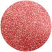 A round red glitter circle with a pink shine on a white background.