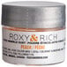 A small container of Roxy & Rich Peach Sparkle Dust powder with a logo.