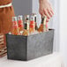 a hand holding a bottle of beer