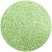 A circle of apple green Roxy & Rich Lustre Dust with a green glitter finish.