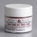 A white container of Roxy & Rich Rouge Flambe Red Lustre Dust with a white lid.