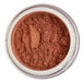 A jar of brown powder labeled "Roxy & Rich Rouge Flambe Red Lustre Dust" on a white surface.