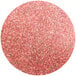 A pink circle with red-orange glitter.