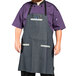 A man with a beard wearing a Uncommon Chef Zig Zag Denim Renegade Bib Apron.