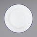 A Crow Canyon Home white enamelware plate with blue rim.