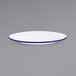 A white Crow Canyon Home enamelware plate with a blue rim.