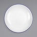 A white Crow Canyon Home enamelware plate with a blue rim.
