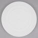 A white plastic Wilton round cake separator plate.