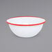 A white bowl with red rim.