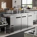 An Avantco stainless steel kegerator with quadruple beer taps.