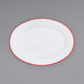 a white plate with red rim