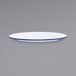 A white Crow Canyon Home enamelware plate with a blue rim.