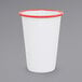 A white Crow Canyon Home enamelware tumbler with red rim.