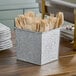 An American Metalcraft galvanized metal rectangular utensil holder with wooden utensils inside.