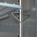 A metal shelf with a metal bar on a metal bracket inside an Avantco refrigerated pizza prep table.