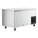 An Avantco stainless steel undercounter refrigerator with drawers and a door on wheels.