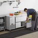 a person putting food into a drawer
