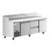 An Avantco stainless steel refrigerated pizza prep table with 2 drawers on wheels.