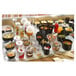 A table full of Solia black plastic tin cans filled with food.