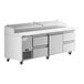 An Avantco stainless steel refrigerated pizza prep table with drawers on wheels.