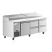 An Avantco stainless steel refrigerated pizza prep table with drawers on wheels.